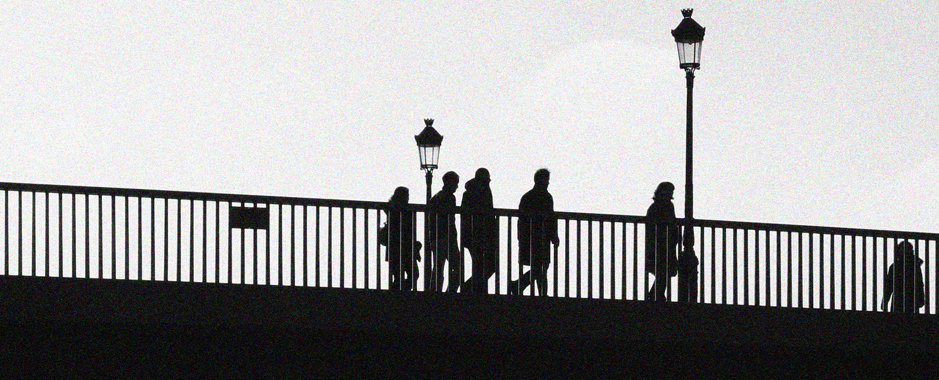 A group crossing a bridge in Paris during a walking guided tour